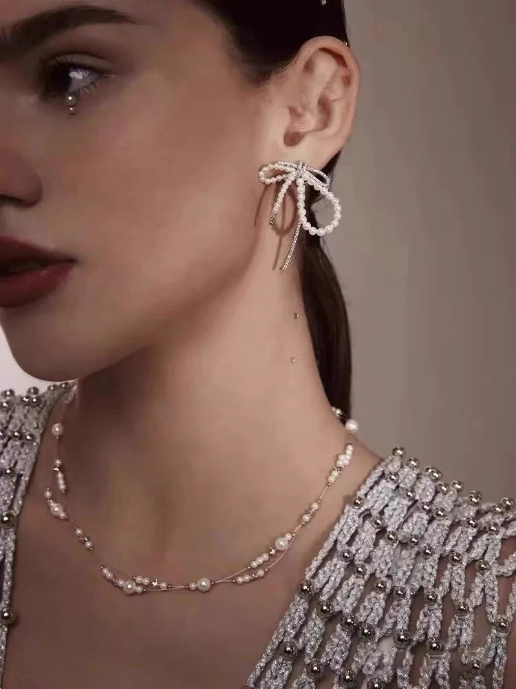 ORECCHINI IN ARGENTO STERLING CON PERLE E FIOCCO